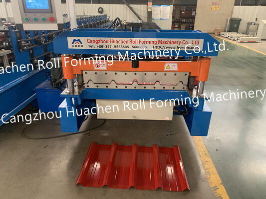 A metal roof panel manufacturing machine for producing tile-shaped corrugated roof panels by rolling process